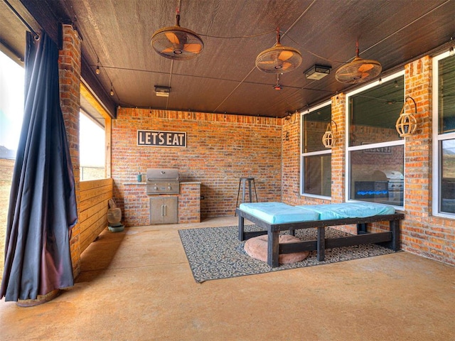 view of patio with area for grilling and ceiling fan