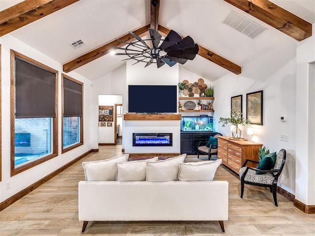 living room with vaulted ceiling with beams, light hardwood / wood-style floors, and ceiling fan