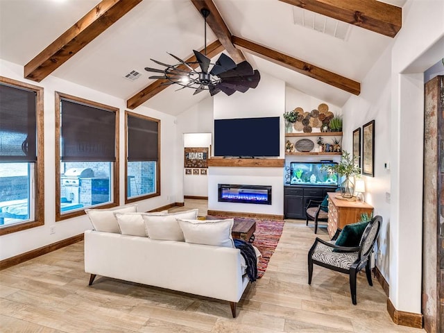 living room featuring ceiling fan, light hardwood / wood-style floors, and vaulted ceiling with beams