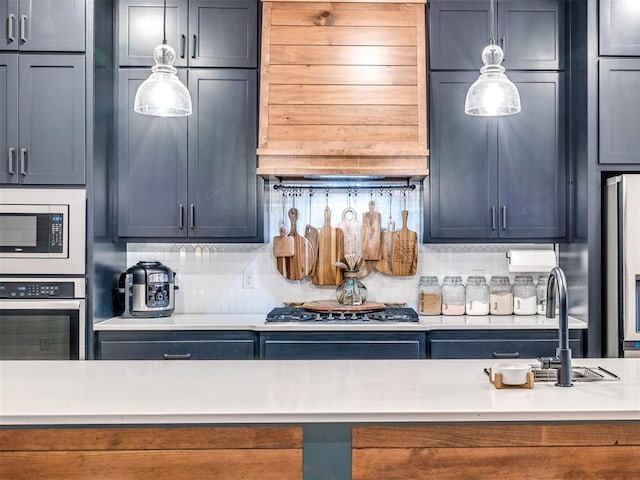 kitchen with extractor fan, appliances with stainless steel finishes, sink, and backsplash