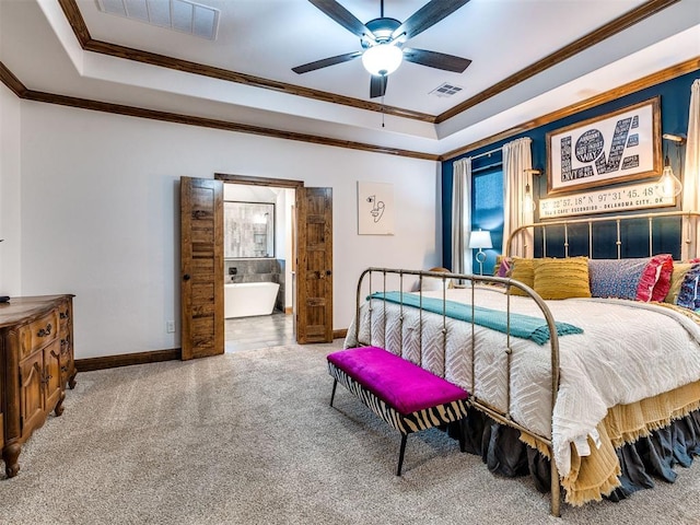 bedroom with crown molding, ceiling fan, ensuite bathroom, carpet, and a tray ceiling