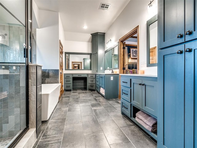 bathroom with vanity and shower with separate bathtub