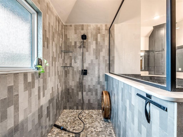 bathroom with a tile shower