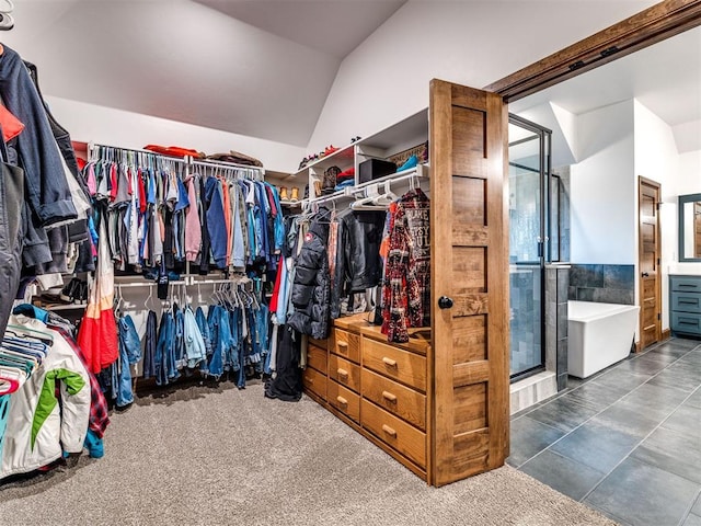 walk in closet featuring vaulted ceiling