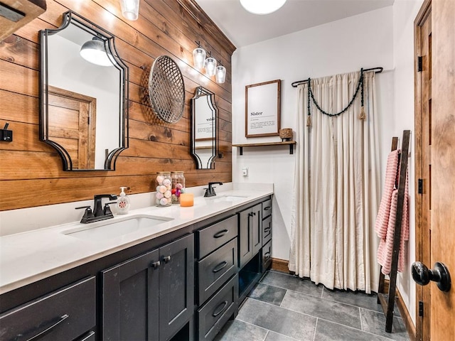 bathroom featuring vanity and wooden walls