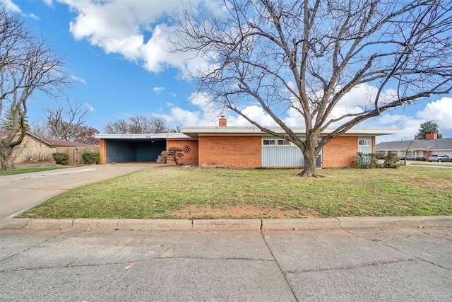 single story home with a front lawn and a carport