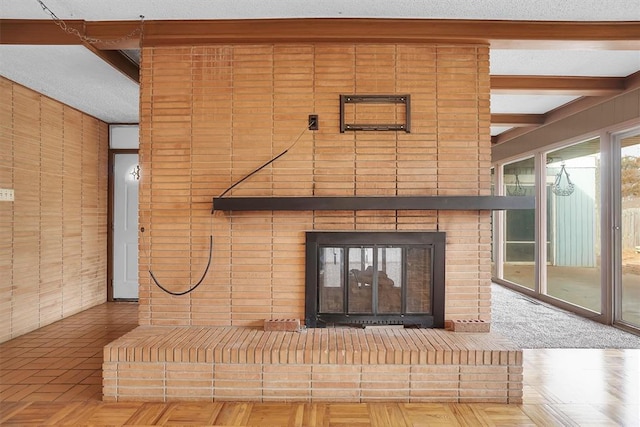 details with beamed ceiling, parquet flooring, and a fireplace