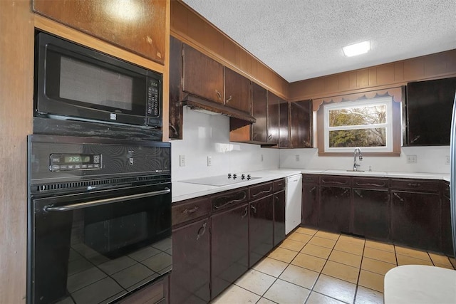 kitchen with sink, light tile patterned floors, black appliances, dark brown cabinets, and a textured ceiling