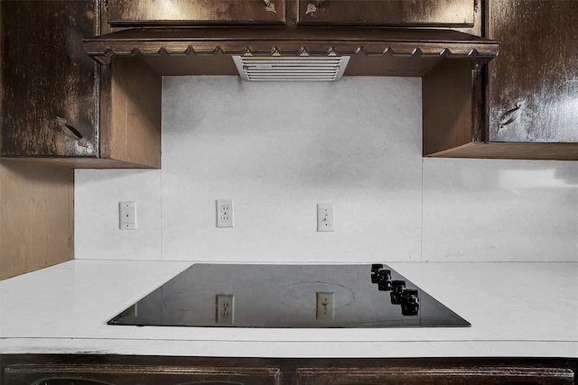 interior space featuring dark brown cabinetry and black electric cooktop