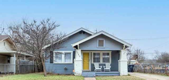 bungalow-style home with a porch and a front yard