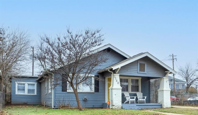 view of front of home with covered porch and a front yard