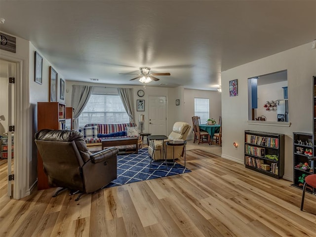 living room featuring ceiling fan and wood-type flooring