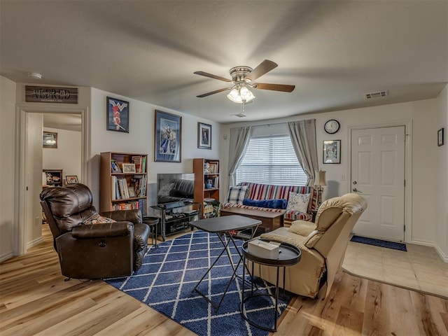 living room featuring hardwood / wood-style flooring and ceiling fan