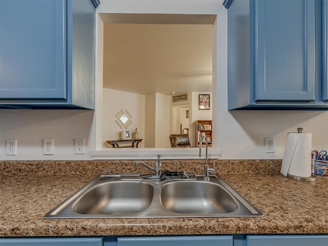 kitchen featuring blue cabinets and sink