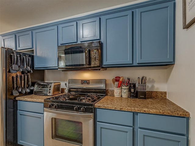 kitchen featuring blue cabinets, fridge, and stainless steel gas range