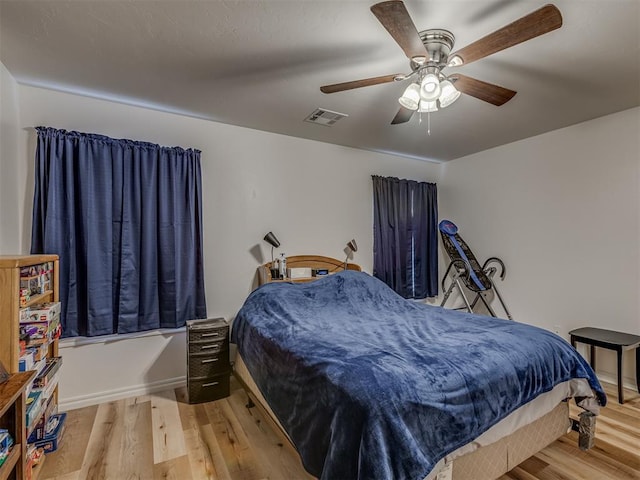 bedroom with hardwood / wood-style floors and ceiling fan