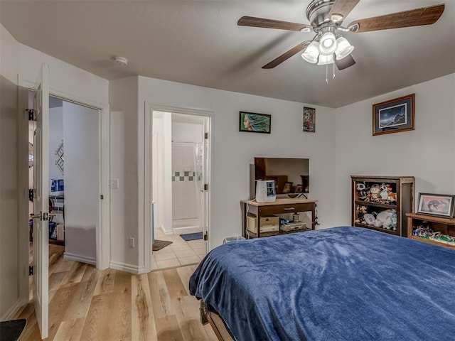 bedroom with ceiling fan, connected bathroom, and light hardwood / wood-style floors