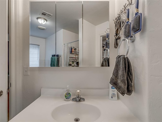 bathroom featuring sink and curtained shower