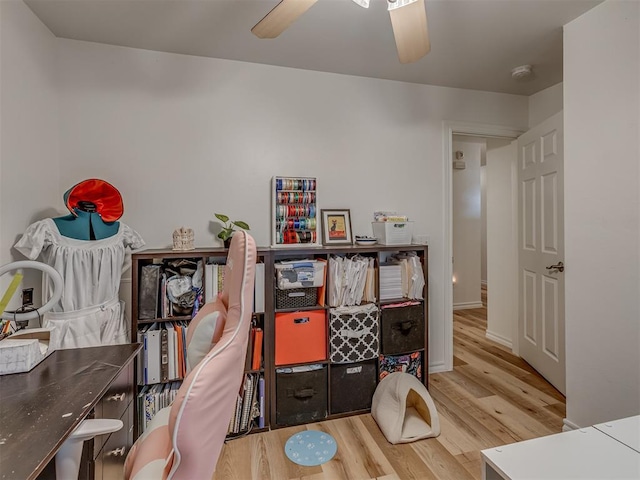 interior space featuring wood-type flooring and ceiling fan