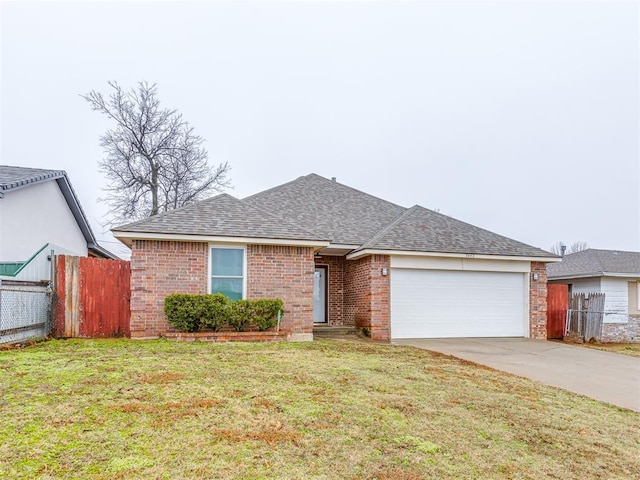 ranch-style home with a garage and a front lawn