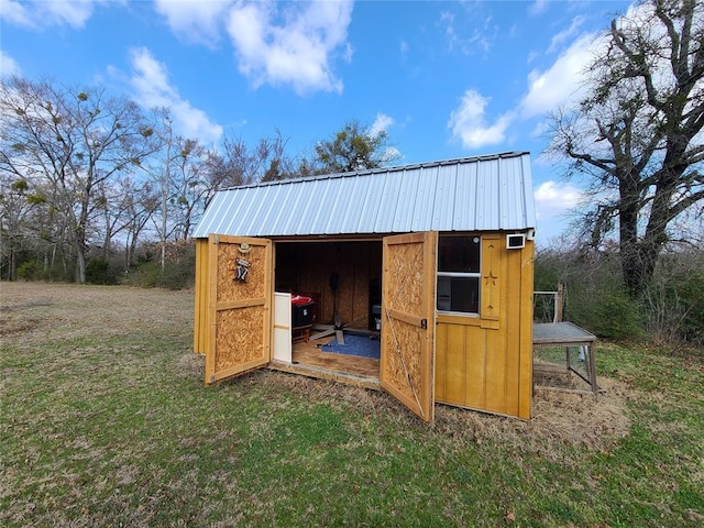 view of outbuilding featuring a lawn