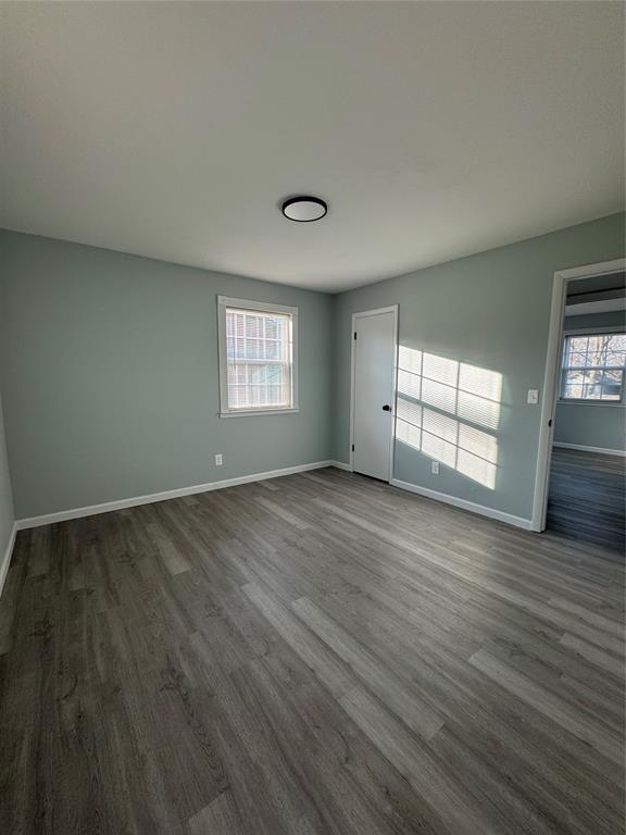 unfurnished room featuring dark hardwood / wood-style flooring