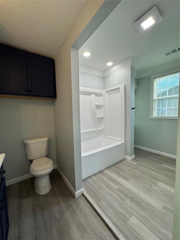 full bathroom with vanity, toilet, shower / washtub combination, and wood-type flooring