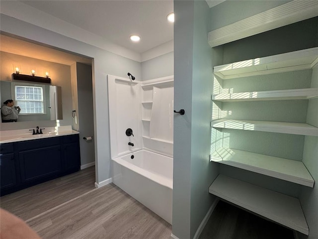 bathroom with vanity, hardwood / wood-style floors, and shower / tub combination