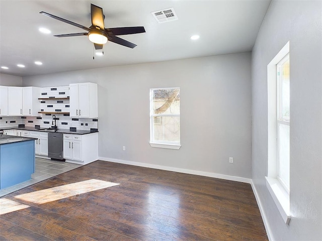 kitchen with white cabinetry, a healthy amount of sunlight, and decorative backsplash