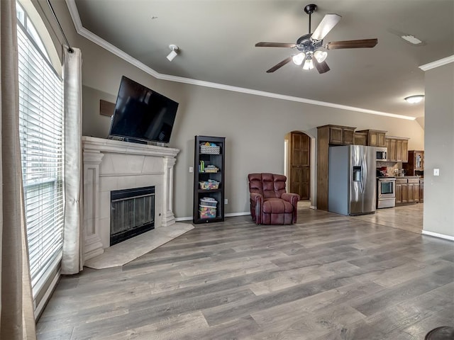 living room with ornamental molding, hardwood / wood-style floors, and plenty of natural light