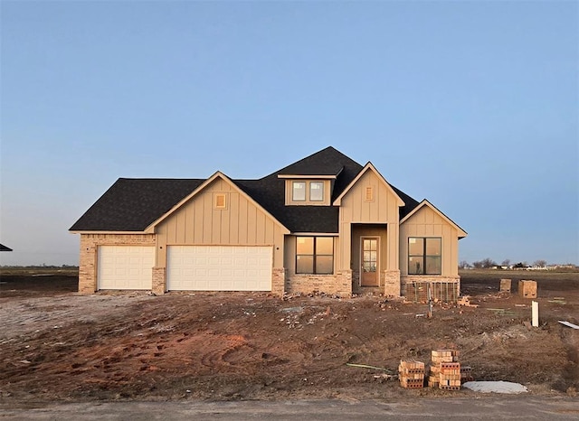 view of front of property with brick siding, board and batten siding, and an attached garage