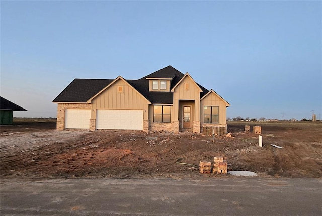 modern inspired farmhouse featuring a garage and board and batten siding