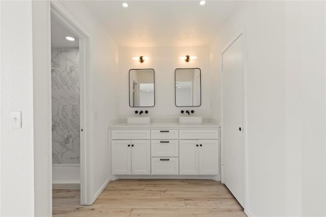 bathroom with vanity and hardwood / wood-style floors