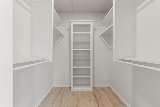 spacious closet with light hardwood / wood-style flooring