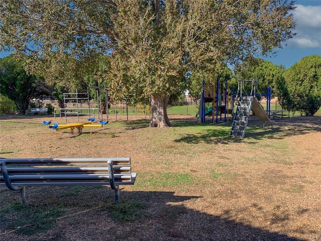 view of property's community with a yard and a playground