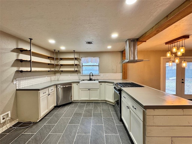 kitchen featuring sink, appliances with stainless steel finishes, ventilation hood, white cabinets, and kitchen peninsula