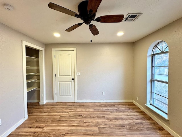 unfurnished room with ceiling fan and light wood-type flooring