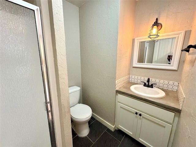 bathroom with vanity, toilet, and tile patterned flooring