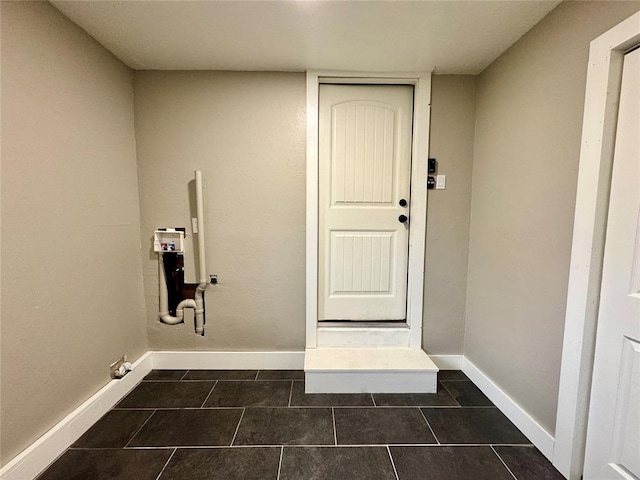 laundry room with dark tile patterned flooring