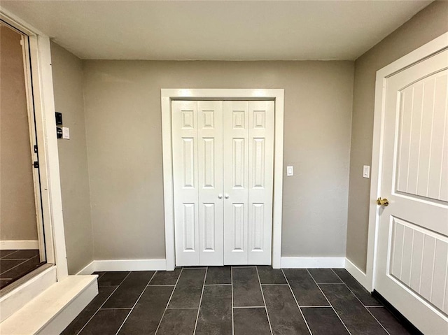 interior space featuring dark tile patterned flooring