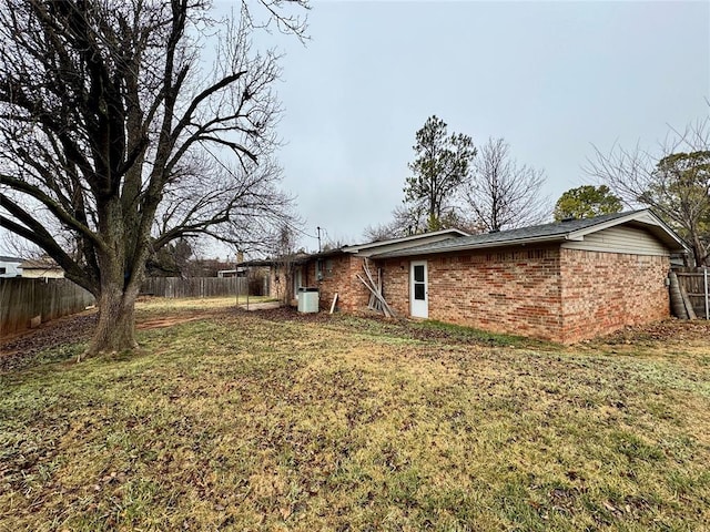 rear view of house featuring a lawn