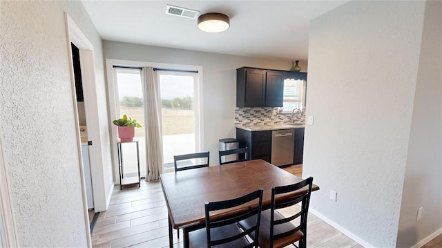 dining room with sink and light hardwood / wood-style flooring