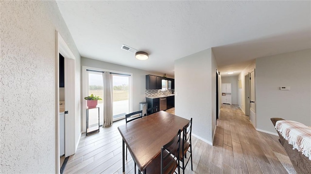 dining space with light hardwood / wood-style flooring