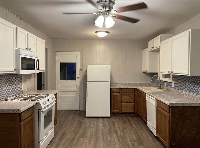 kitchen featuring sink, white appliances, white cabinetry, tasteful backsplash, and dark hardwood / wood-style flooring