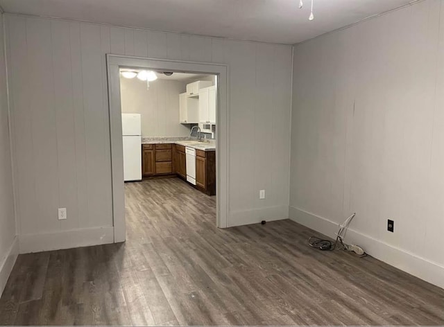 unfurnished living room with sink and dark hardwood / wood-style floors