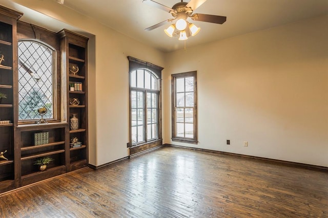 empty room featuring dark hardwood / wood-style floors and ceiling fan