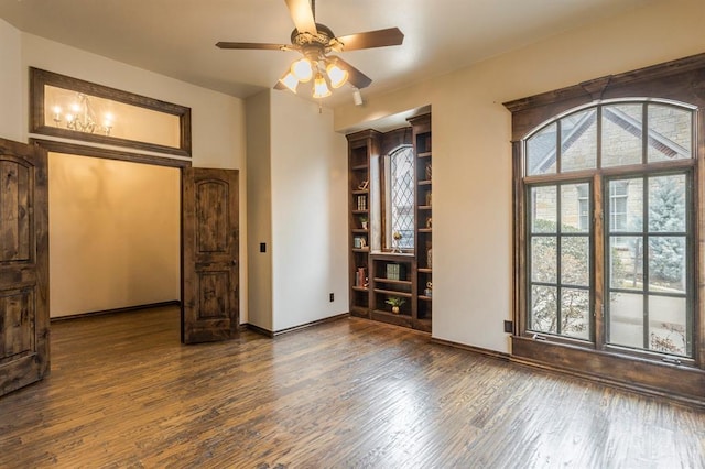 spare room with dark wood-type flooring and ceiling fan