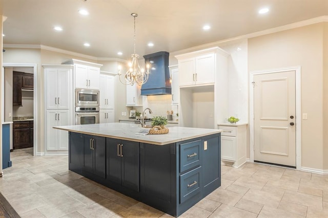 kitchen with white cabinetry, stainless steel appliances, and a kitchen island with sink