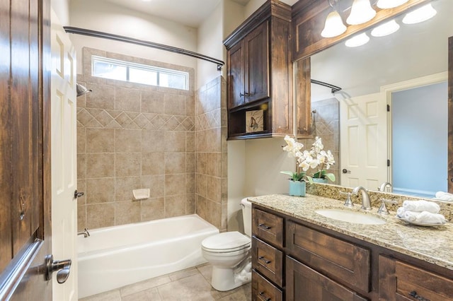 full bathroom featuring vanity, tile patterned floors, toilet, and tiled shower / bath