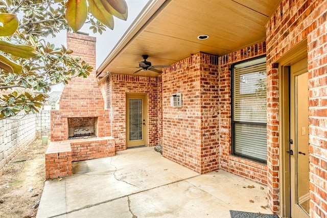 view of patio / terrace with an outdoor brick fireplace and ceiling fan